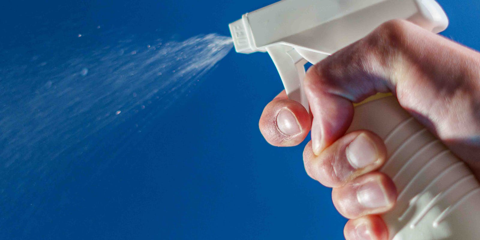 spraying cleaning liquid