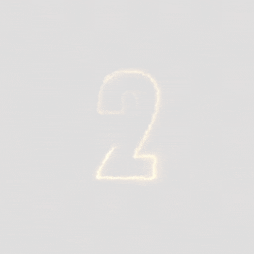 Wood table with porcelain mug, leather journal, brass pen, leather key ring, and a houseplant.