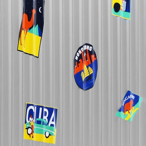 Closeup of stickers on SUITCASEƎ Globetrotter Aluminium Cabin Bag, durable metal carry-on suitcase with custom travel decals.