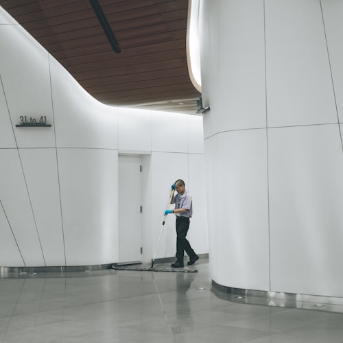 man sweeping the floor