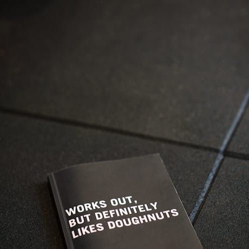 Person using a pen to cross a task off a productivity paper card.