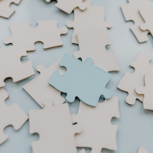 Person using a pen to cross a task off a productivity paper card.